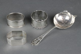A silver tea strainer Sheffield 1954, 3 silver napkin rings, 102 grams