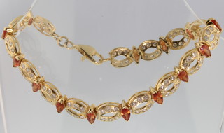 A Continental gold diamond and gem set open bracelet, gross 16 ozs (Lacking one diamond)