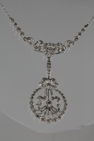 An 18ct white gold diamond open floral brooch on an 18ct white gold chain, approx 1.80ct 