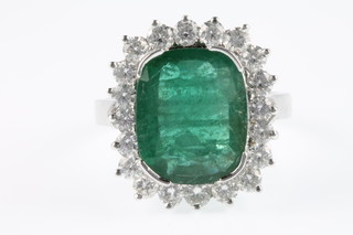 An 18ct white gold emerald and diamond cluster ring, the centre emerald approx. 5.3ct surrounded by 20 brilliant cut diamonds, approx. 1.3ct size P 1/2