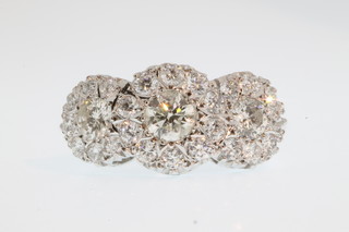 An 18ct white gold triple cluster diamond ring, approx. 1.85ct, size O