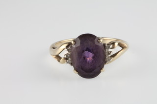 A 9ct amethyst and diamond ring with open shoulders, size P 1/2
