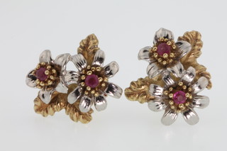 A pair of 2 colour 10ct floral gem set ear studs