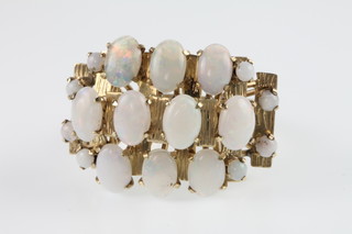 A 1970's 14ct yellow gold high mount 18 stone opal cluster ring, size N