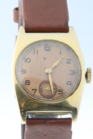 A gentleman's 9ct gold tonneau shaped wristwatch, the gilt dial with seconds at 6 o'clock  