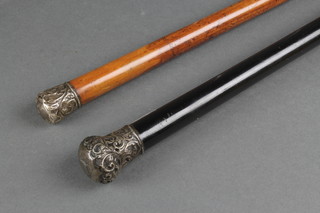 2 Edwardian walking canes with repousse silver knops 