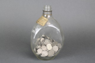 A Dimple bottle containing a quantity of post 1947 sixpences 