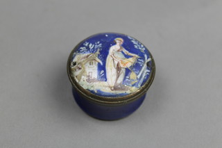 An 18th Century circular enamel patch box with a lady before a country house, mirrored interior, 1" (f)