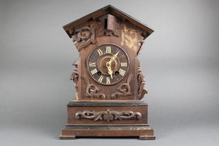 A 19th Century cuckoo mantel clock contained in a carved hardwood case 