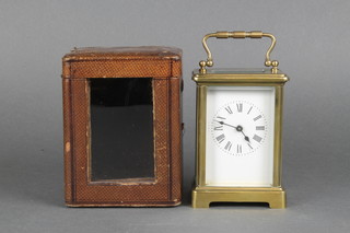 A 19th Century French 8 day carriage clock with enamelled dial and Roman numerals contained in a gilt metal case, complete with outer leather case 