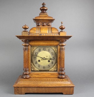 An Edwardian 8 day striking bracket clock with square gilt dial, silvered chapter ring and Arabic numerals, contained in a carved oak case 