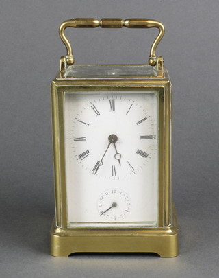 A 19th Century French 8 day carriage alarm clock with enamelled dial and Roman numerals, contained in a gilt metal case 