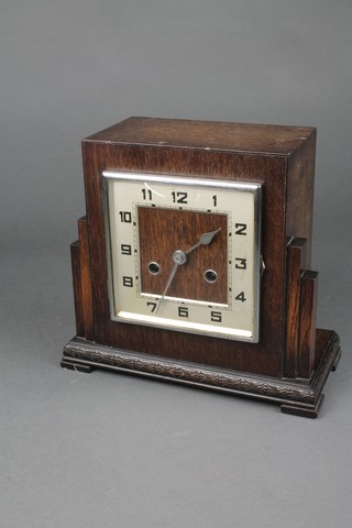 A 1930's Art Deco 8 day striking mantel clock with square silvered dial, Arabic numerals contained in an oak case 
