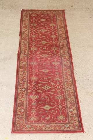 A red ground machine made Persian style runner 105" x 27"