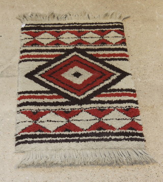 A brown and white ground Zulu Valley rug 24" x 27"