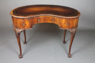 A Queen Anne style walnut writing table with brown inset skiver and gadrooned border, the base fitted 1 long and 2 short drawers, raised on cabriole and claw supports 30"h x 42"w x 21"d 