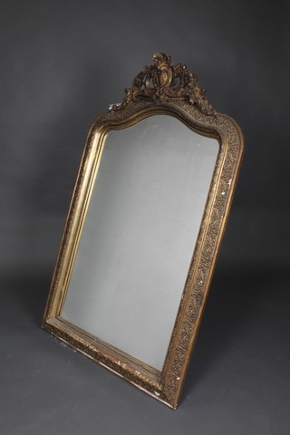 A 19th Century Continental arched plate mirror contained in a decorative gilt frame 60"h x 36"w 
