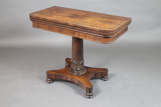 A William IV rosewood D shaped card table raised on a turned column and triform base on 4 bun feet 29 1/2"h x 26"w x 18"d