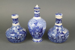 A pair of Wedgwood blue and white advertising decanters and stoppers for Humphrey Taylor & Co decorated with riverscape, a ditto bottle vase 