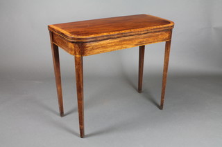 A Georgian mahogany and crossbanded D shaped card table, raised on square tapering supports 29"h x 34"w x 16 1/2"d 