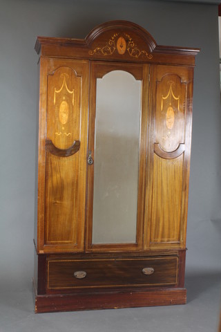An Edwardian inlaid mahogany wardrobe with arch shaped cornice, enclosed by an arched bevelled plate mirror panelled door, the base fitted 1 long drawer 85 1/2"h x 48"2 x 18"d