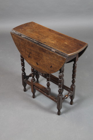 An 18th Century oak oval drop flap, gateleg tea table, raised on bobbin turned supports 24 1/2"h x 24"w x 9" when closed x 29 1/2" when open 