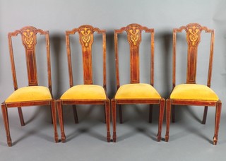 A set of 4 Edwardian inlaid mahogany slat back dining chairs with upholstered drop in seats, raised on square tapering supports, spade feet