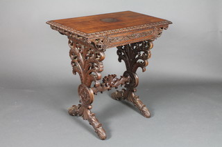 A Victorian Anglo-Indian carved rosewood table fitted a frieze drawer, raised on pierced panel supports with H framed stretcher 29"h x 30"l x 18"w 