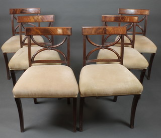 A set of 6 Regency style mahogany bar back dining chairs with X framed bar backs, raised on sabre supports