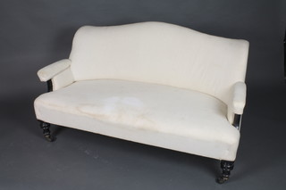 A Victorian 3 seat sofa with upholstered seat and back in white material, raised on ebonised turned supports 