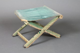 A Roman style X framed folding stool upholstered in green velvet and with studded decoration 12"h x 18"w x 13"d
