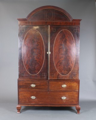 A 19th Century Sheraton style inlaid mahogany linen press with arched cornice, the interior fitted 4 trays enclosed by oval panelled doors, the base fitted 2 short and 1 long drawers with brass drop handles, raised on cabriole supports 86"h x 50"w x 24"d  
