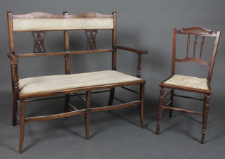 An Edwardian inlaid mahogany double chair back settee with upholstered seat, raised on shaped supports with stretcher together with a walnut bedroom chair with ring turned decoration 