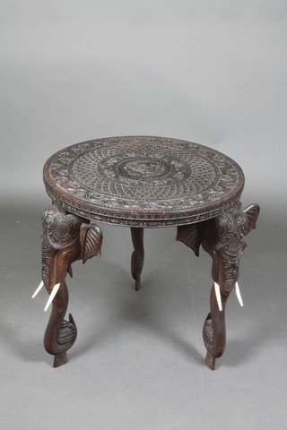 An Anglo Indian carved hardwood circular occasional table, raised on 3 elephant supports 24"h x 23 1/2" diam. 