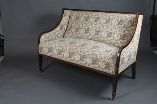An Edwardian 7 piece inlaid mahogany drawing room suite comprising a winged 2 seat show frame sofa, 2 matching armchairs and 4 standard chairs with upholstered seats and backs, raised on square tapered supports