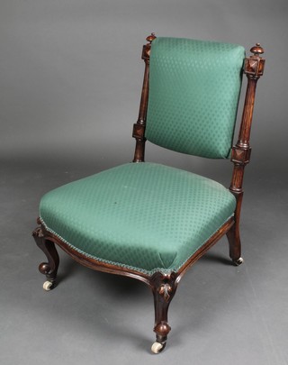 A Victorian mahogany show frame nursing chair with fluted columns to the back, raised on cabriole supports 