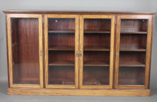 A Victorian walnut triple bookcase, the interior fitted adjustable shelves enclosed by glazed panelled doors, raised on a platform base 48"h x 84"w x 14"d 