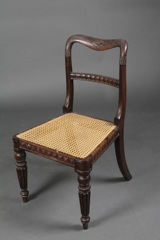 A William IV carved rosewood spoon back chair with carved mid rail and woven cane seat on turned and reeded supports