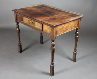 A Continental Queen Anne style walnut dressing/writing table with pierced brass three-quarter gallery, the apron fitted 1 long drawer, raised on turned supports 31"h x 36"w x 23 1/2"d 