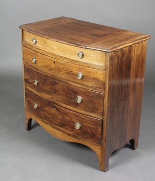 A 19th Century mahogany bow front commode with hinged lid and fitted interior above 3 long drawers with brass ring drop handles, raised on bracket feet, 29"h x 28 1/2"l x 17"d 
