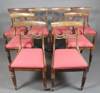 A set of 8 Georgian mahogany bar back dining chairs with carved mid rails, raised on turned and reeded supports 