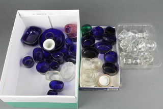 A quantity of blue glass condiment liners and clear glass eye baths