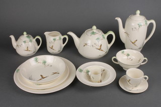 A Royal Doulton The Coppice tea, coffee and dinner service comprising coffee pot, tea pot, 2 breakfast teapots, 2 milk jugs, 1 cream jug, 2 sugar bowls, 6 coffee cups, 6 saucers, 5 tea cups, 7 saucers, four 2 handled bowls, 5 egg cups, 12 side plates, 8 medium plates, 6 dinner plates, 6 dessert bowls, 2 serving bowls and a sandwich plates