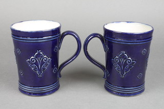 A pair of Royal Doulton blue glazed waisted mugs, impressed 7371 and 7372 5 1/2" 