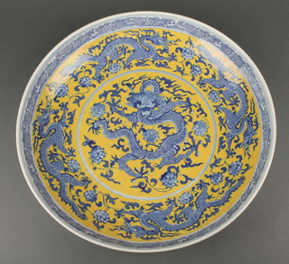 A Chinese yellow ground charger decorated with dragons amongst flowers, bearing 6 character mark to the base 17" 