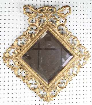 A Victorian diamond shaped bevelled plate wall mirror contained in a pierced gilt metal frame 18"h x 17"w 
