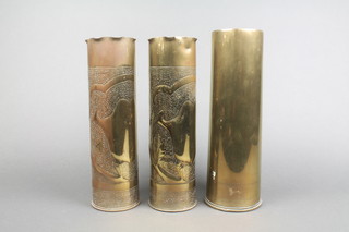 A pair of Trench Art vases formed from 16lb Continental shells together with a WWI brass 18lb shell case dated 1914 