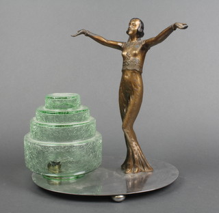 An Art Deco spelter, chrome and glass table lamp in the form of a standing lady with outstretched arms, raised on a circular chromium plated base with green glass shade 10" 