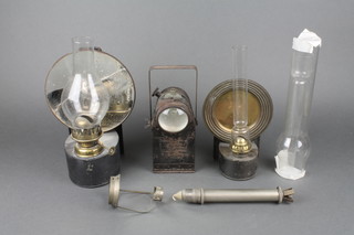 2 19th/20th Century stable style pressed metal wall mounting lanterns with reflectors (1f), a candle holder and 2 glass chimneys 