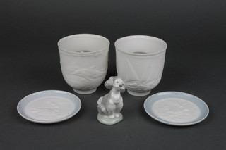 A 1997 Lladro Collectors Society tea light holder with lithopane panels decorated yachts 4", ditto 1998 decorated dolphins, ditto 2000 figure of a seated puppy 3" together with 2 Lladro circular porcelain plaques with lithopane panels decorated birds 4", all boxed 